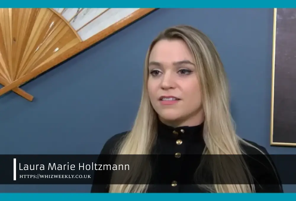 Laura Marie Holtzmann smiling outdoors with scenic view