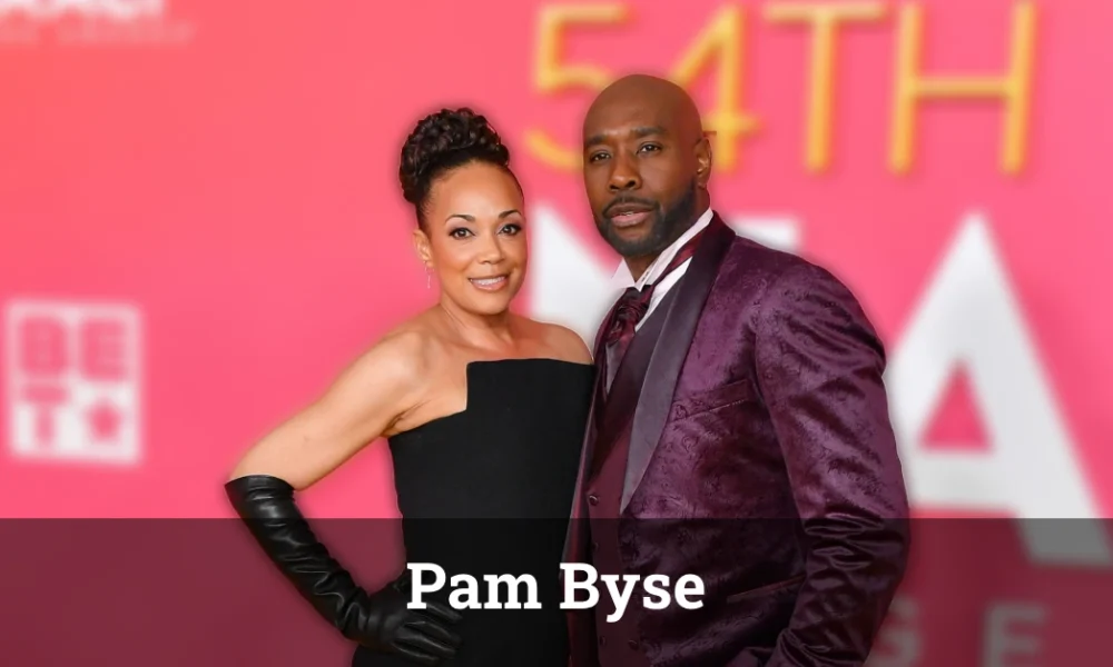 Pam Byse and Morris Chestnut at a formal event, smiling together.