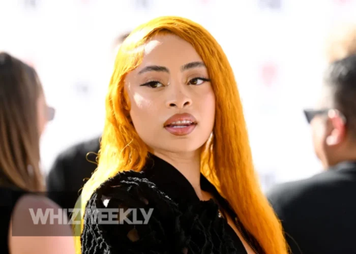 Ice Spice Net Worth and his performing on stage, with her signature ginger hair and a microphone.