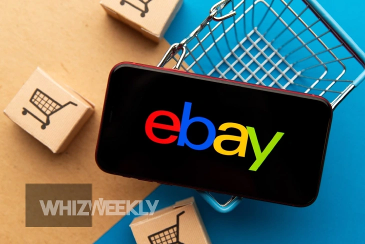 Shopping smartphone displaying eBay logo with miniature cart - iloveloveloveebay.com helps unlock hidden deals and expert strategies for smarter online shopping