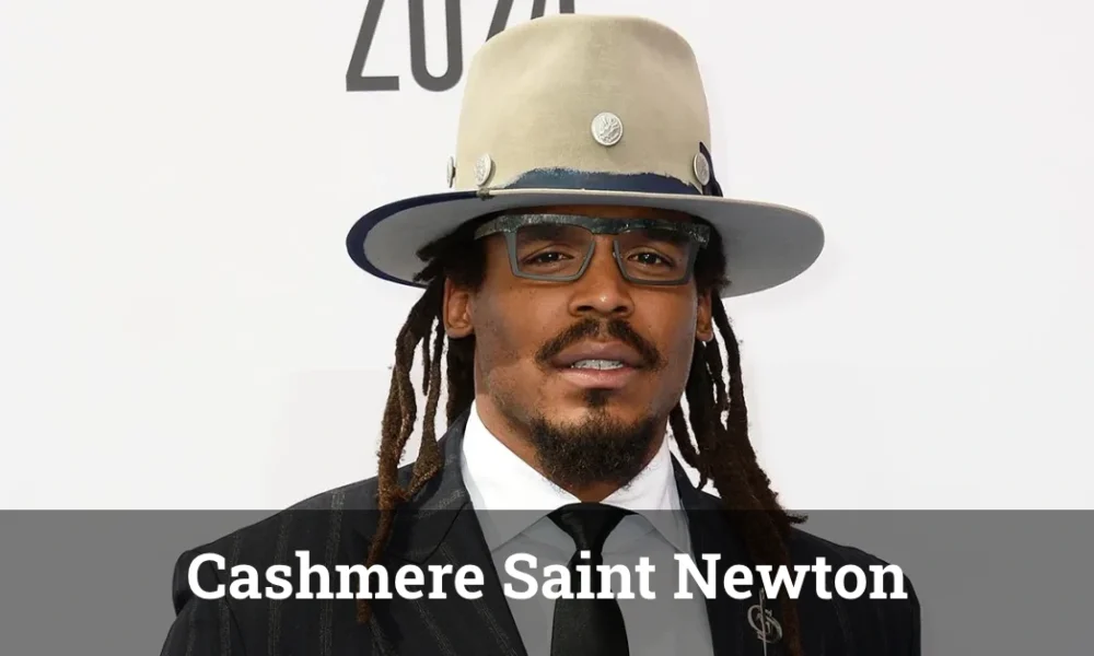 Cashmere Saint Newton posing confidently in a stylish outfit with a well-lit background.