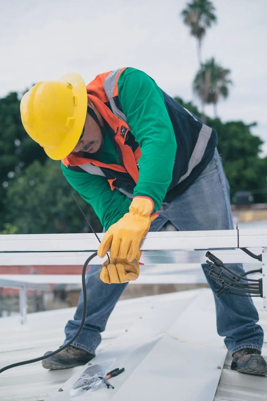 Worker installing durable post support on a construction site for enhanced safety and stability