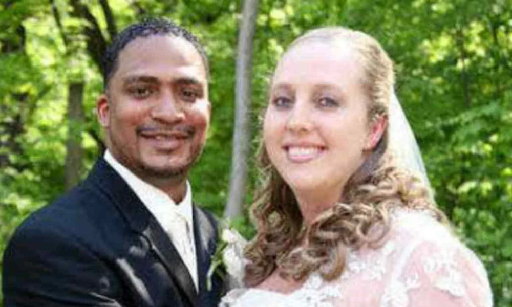 Larry Bird’s Daughter Corrie Bird – A Story of Strength and Success Corrie Bird on her wedding day with husband Trent Batson in formal attire against a green natural background