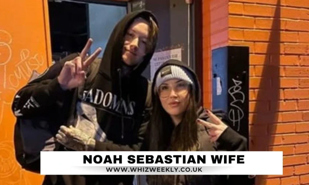 Noah Sebastian Wife: The Private Force Behind Bad Omens’ Frontman Noah Sebastian Wife, both dressed in stylish streetwear, showing peace signs outside a vibrant urban venue.