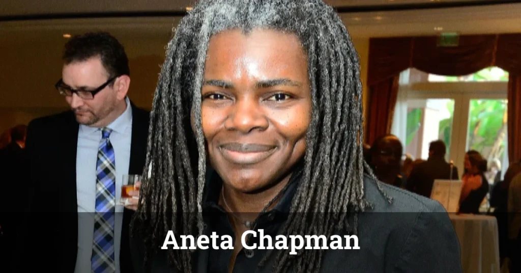 Person with long dark dreadlocks at formal event - labeled as Aneta Chapman