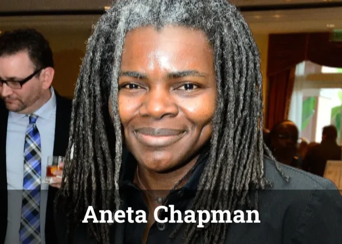 Person with long dark dreadlocks at formal event - labeled as Aneta Chapman