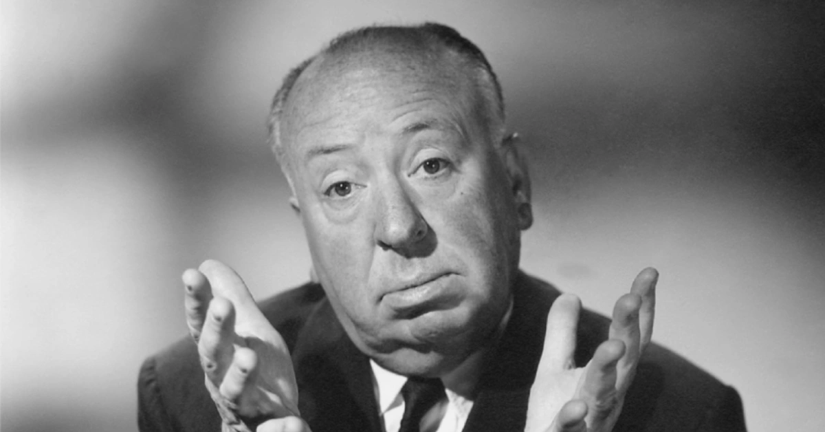 Alfred Hitchcock Net Worth: The Master of Suspense gesturing dramatically in his iconic pose that helped build his $200 million fortune