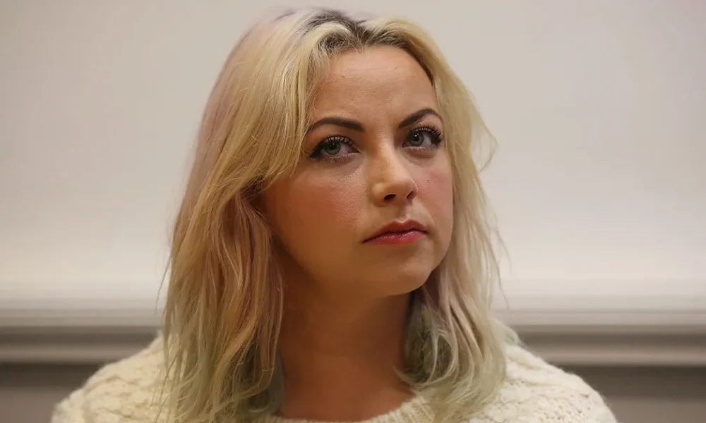 Charlotte Church smiling at an event, representing her success and the story behind Charlotte Church Net Worth.