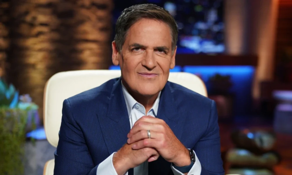 Cuban smiling on Shark Tank set, symbolizing Cuban Net Worth and his journey as a billionaire entrepreneur.