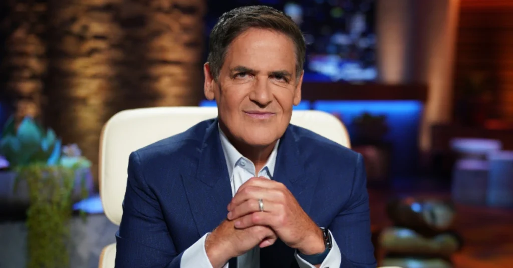 Cuban smiling on Shark Tank set, symbolizing Cuban Net Worth and his journey as a billionaire entrepreneur.