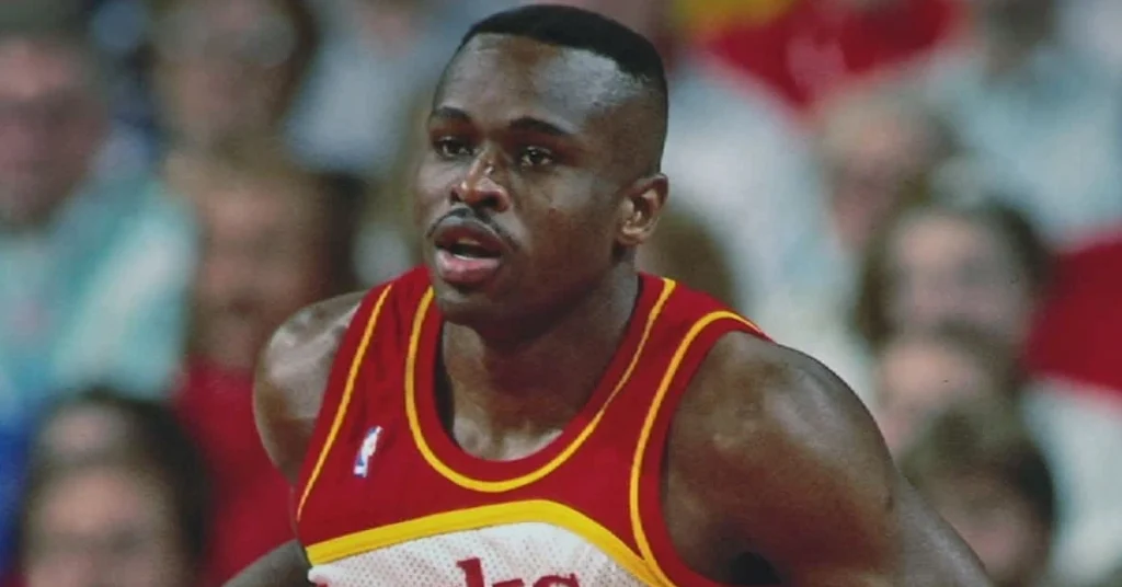 Rumeal Robinson in Atlanta Hawks uniform during an NBA game, showcasing his basketball career.