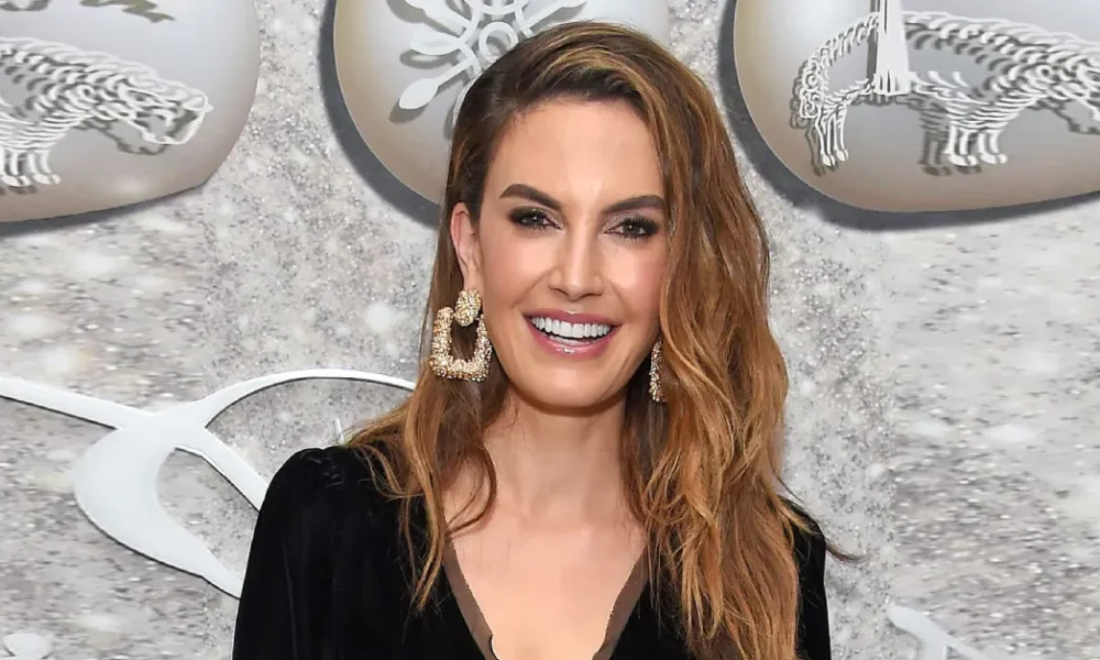 Elizabeth Chambers at a glamorous event in a black outfit and bold earrings, representing her success and Elizabeth Chambers Net Worth.