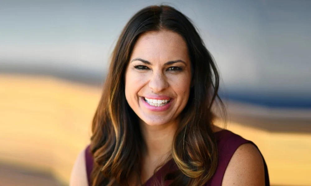 Jessica Mendoza: From Olympic Softball Star to Pioneer Baseball Analyst Jessica Mendoza smiling confidently in purple attire, representing her transition from Olympic softball champion to pioneering ESPN baseball analyst breaking gender barriers.