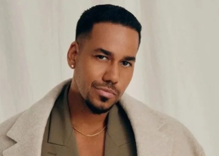 Romeo Santos featured in 2025 spotlight article, dressed stylishly and posing confidently during a public appearance.