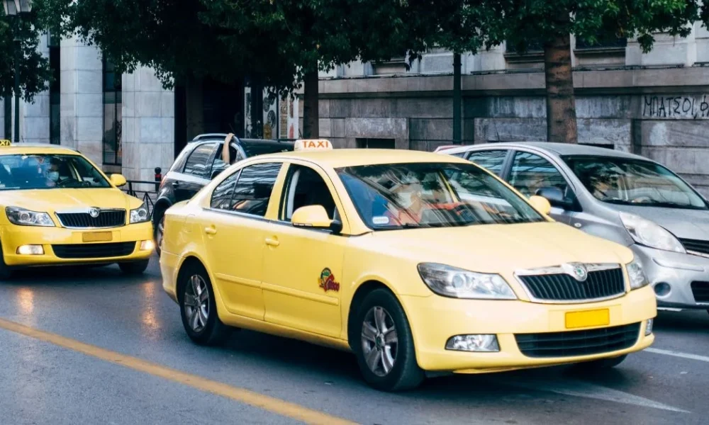 Taxi rank outside Gatwick Airport with licensed cabs waiting for passengers.