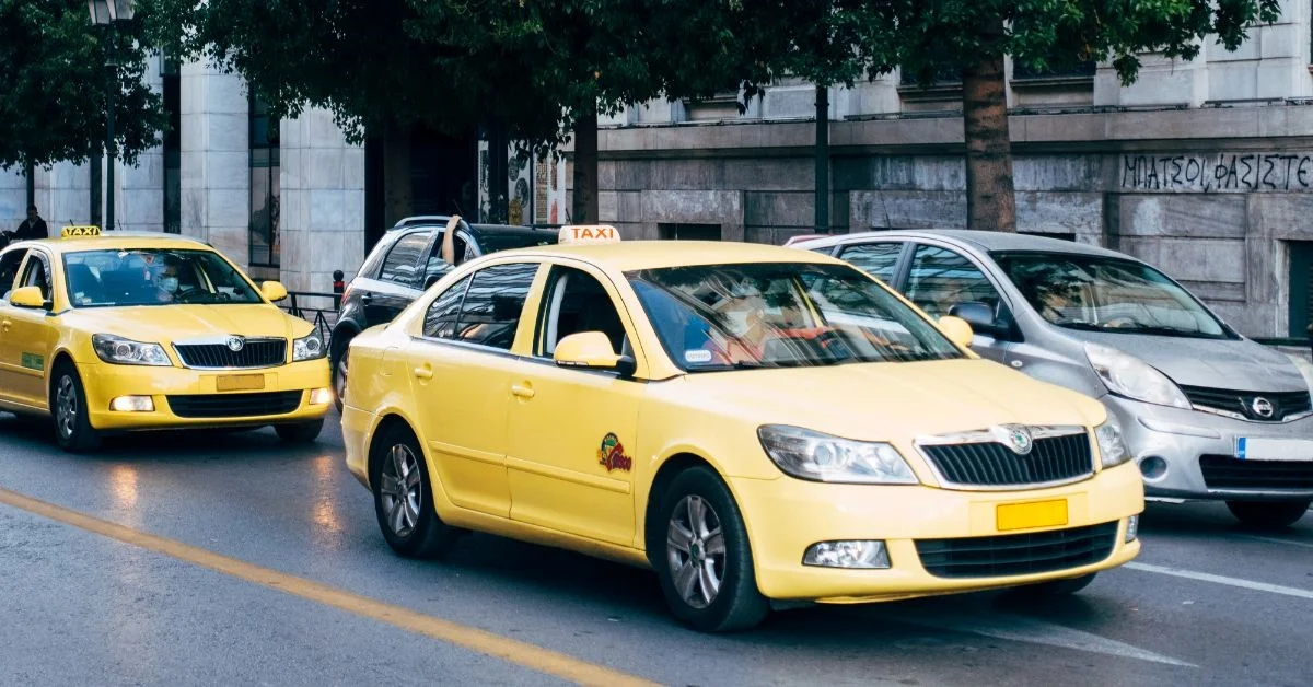 Taxi rank outside Gatwick Airport with licensed cabs waiting for passengers.